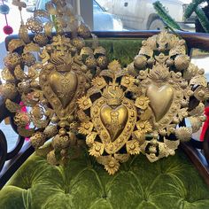 an elaborately decorated chair with heart shaped ornaments on it's back and sides