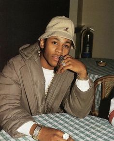 a person sitting at a table with a hat on