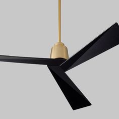 a ceiling fan that is black and gold with a light on the top of it