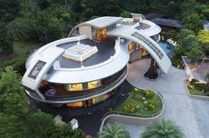 an aerial view of a modern house surrounded by trees