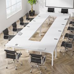 an empty conference table with chairs around it