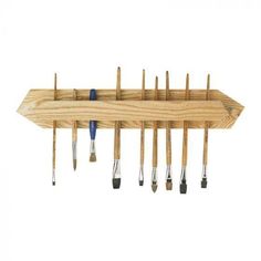 a wooden wall mounted tool rack with tools hanging from it's sides and two blue handles on each side