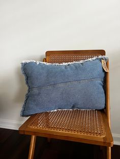 a blue pillow sitting on top of a wooden chair