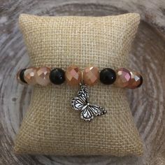 This butterfly bracelet is inspired by monarch butterflies and has a silver butterfly charm. Monarch Butterflies, Brown Bracelet, Butterfly Bracelet, Silver Butterfly, Butterfly Charm, Monarch Butterfly, Arm Band, Butterflies, Jewelry Bracelets