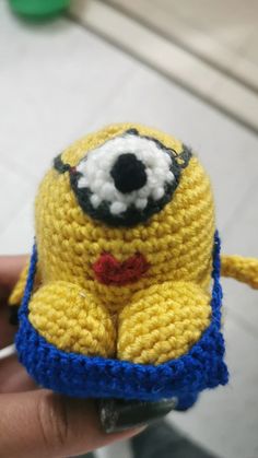 a crocheted yellow and blue stuffed animal