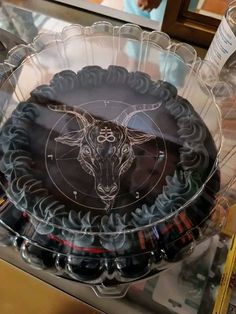 there is a cake in the shape of a bull head on it's plate