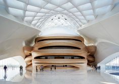 the inside of a building with people walking around