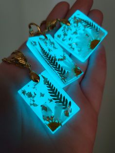 glow in the dark jewelry with fern leaves on them