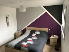 a bed room with a neatly made bed next to a window and a painting on the wall