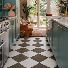 a kitchen with green cabinets and checkered flooring on the floor is pictured in this image