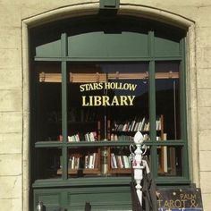 there is a book store with books on the shelves and an umbrella in front of it