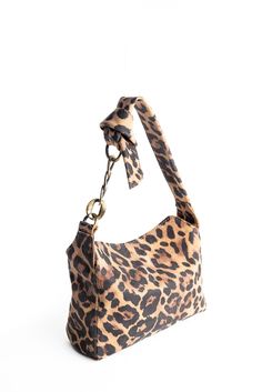 This elegant leopard printed purse is a perfect accessory to wear during the day as well as during a night out, to bring an edgy twist to your outfit.  Its size is really practical: you can fit in your cell phone, your make-up, a small purse, your keys, agenda, etc.  Inside: fabric lining, one pocket with zipper and two open pockets for cards and cell phone. MEASURES: Height: 7.5" (19 cm) / Width: 11" (28 cm) / Deep: 4.7" (12 cm)   Strap Length: 23.6" (60 cm)  Shipping: this bag  is made to order, please allow 10 working days for delivery.  Shipping through private courier only 4-5 business days to reach any destination. Chic Leopard Print Tote Shoulder Bag, Chic Everyday Leopard Print Shoulder Bag, Leather Shoulder Bag In Leopard Print For Everyday, Trendy Leopard Print Bag With Detachable Strap, Everyday Leopard Print Leather Shoulder Bag, Chic Leopard Print Satchel Shoulder Bag, Leopard Print Shoulder Bag With Detachable Strap For Evening, Leopard Print Tote Shoulder Bag With Gold-tone Hardware, Evening Shoulder Bag In Leopard Print With Detachable Strap