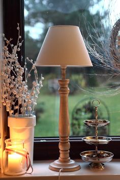 a lamp sitting on top of a window sill