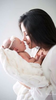 a woman holding a baby in her arms