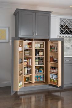 an open cabinet in the middle of a kitchen