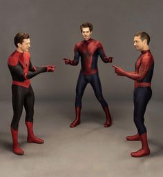 three men in spider - man suits are talking to each other on a gray background