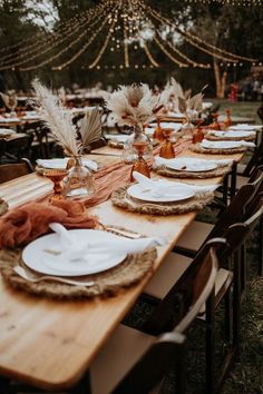 a long table set with plates and place settings