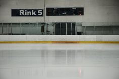 an empty ice rink with a sign on the wall above it that says rink 5