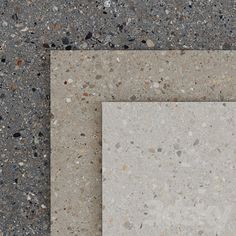 two square tiles sitting on top of each other in the middle of a flooring area