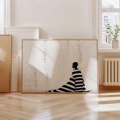 an art piece is displayed in front of a white wall with a black and white striped dress on it