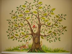 a painting of a tree with leaves and a bird on the branch is painted on the wall