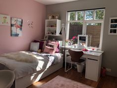 a bedroom with pink walls and white furniture