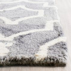 a gray and white rug on the floor