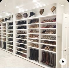 a large white closet filled with lots of shoes