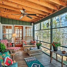 a porch with lots of windows and furniture