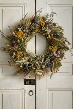 a white door with a wreath hanging on it