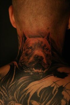 a man with a tattoo on his neck has a dog's face painted on it