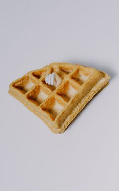 a waffle shaped like a piece of bread with icing on the top and bottom