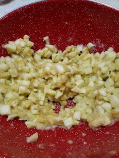 a red plate topped with food on top of a white table next to utensils