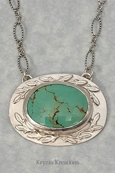 Nature-Inspired Turquoise Pendant Necklace in Sterling Silver with Leaves Turquoise Necklace With Large Oval Stone Pendant, Turquoise Necklace With Large Oval Pendant, Turquoise Necklace With Large Oval Stone, Oval Turquoise Necklace With Natural Stones, Elegant Oval Turquoise Necklace With Large Pendant, Oval Cabochon Necklace With Nature-inspired Style, Oval Turquoise Necklace With Large Pendant, Green Oval Cabochon Turquoise Necklace, Oval Turquoise Necklace With Large Sterling Silver Pendant