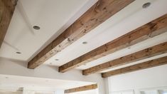 a living room filled with furniture and wooden beams