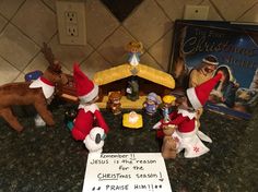 three christmas elf figurines and a sign on a kitchen counter with the last christmas night written in front of them