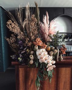 a wooden counter topped with lots of flowers