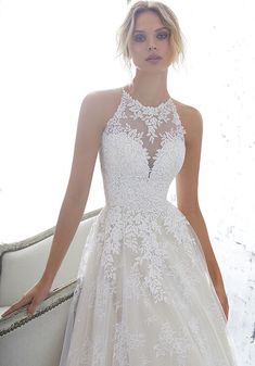 a woman in a wedding dress posing for the camera