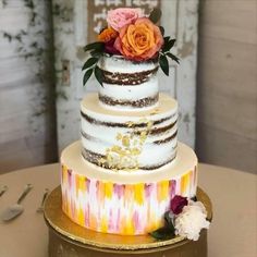 a multi layer cake with flowers on top