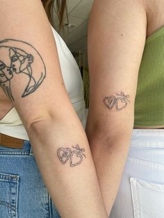 two women with matching tattoos on their arms