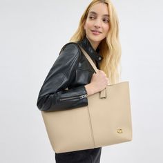 Going places? Take our practical-yet-polished North along for the ride. Crafted of supple double-faced lightly grained leather with an ultra-luxe soft feel this snap-closure tote is finished with an inside zip pocket and our Signature hardware. With space for a 13” laptop it’s a minimalist sophisticated style that’s great for work (and play). | Coach North Tote 32 - Women's - Brass/ivory Versatile Coach Bags In Soft Leather, Coach Beige Shoulder Bag For Work, Versatile Coach Soft Leather Bag, Versatile Coach Tote Bag, Coach Shoulder Bag For Office With Large Capacity, Versatile Coach Bags Suitable For Work, Versatile Coach Bags For Work, Coach Bags With Smooth Grain For Everyday Use, Coach Tote Shoulder Bag For Work