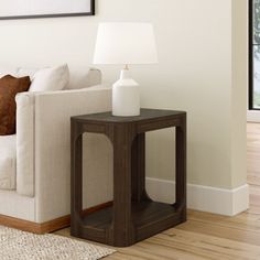 a living room with a white couch and wooden table