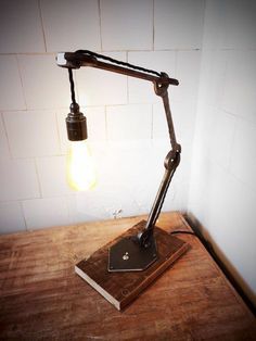 a lamp that is sitting on top of a wooden table next to a light bulb