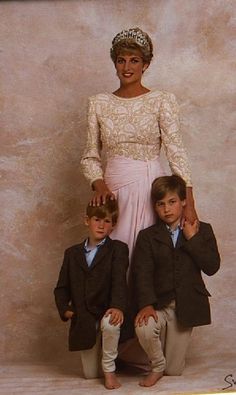 a woman and two boys are posing for a photo