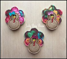 three turkey brooches are sitting on a table