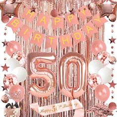 a pink 50th birthday party with balloons and streamers