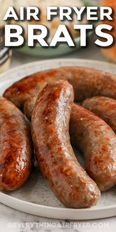 some sausages are on a plate with the words air fryer brats