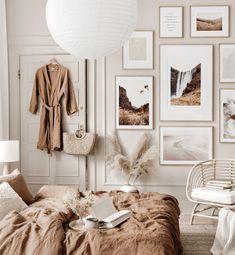 a bedroom with white walls and pictures on the wall