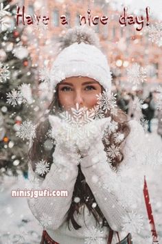 a woman is covering her face with snow flakes