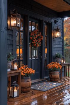 two wooden planters filled with orange flowers sitting on a porch next to a blue door